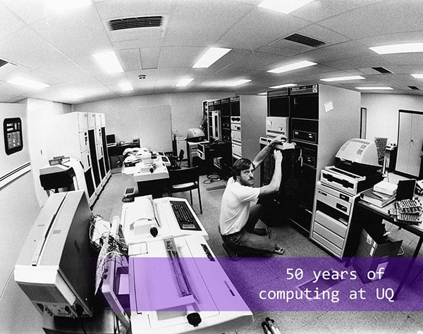 Man fixing first computer at UQ