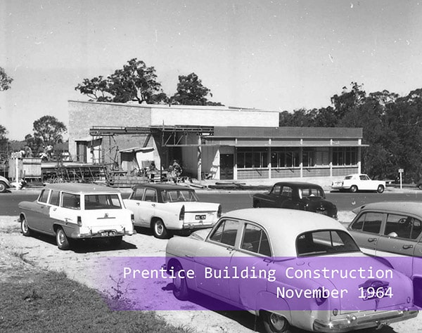 Cars parked outside of the Prentice Centre construction site in 1964